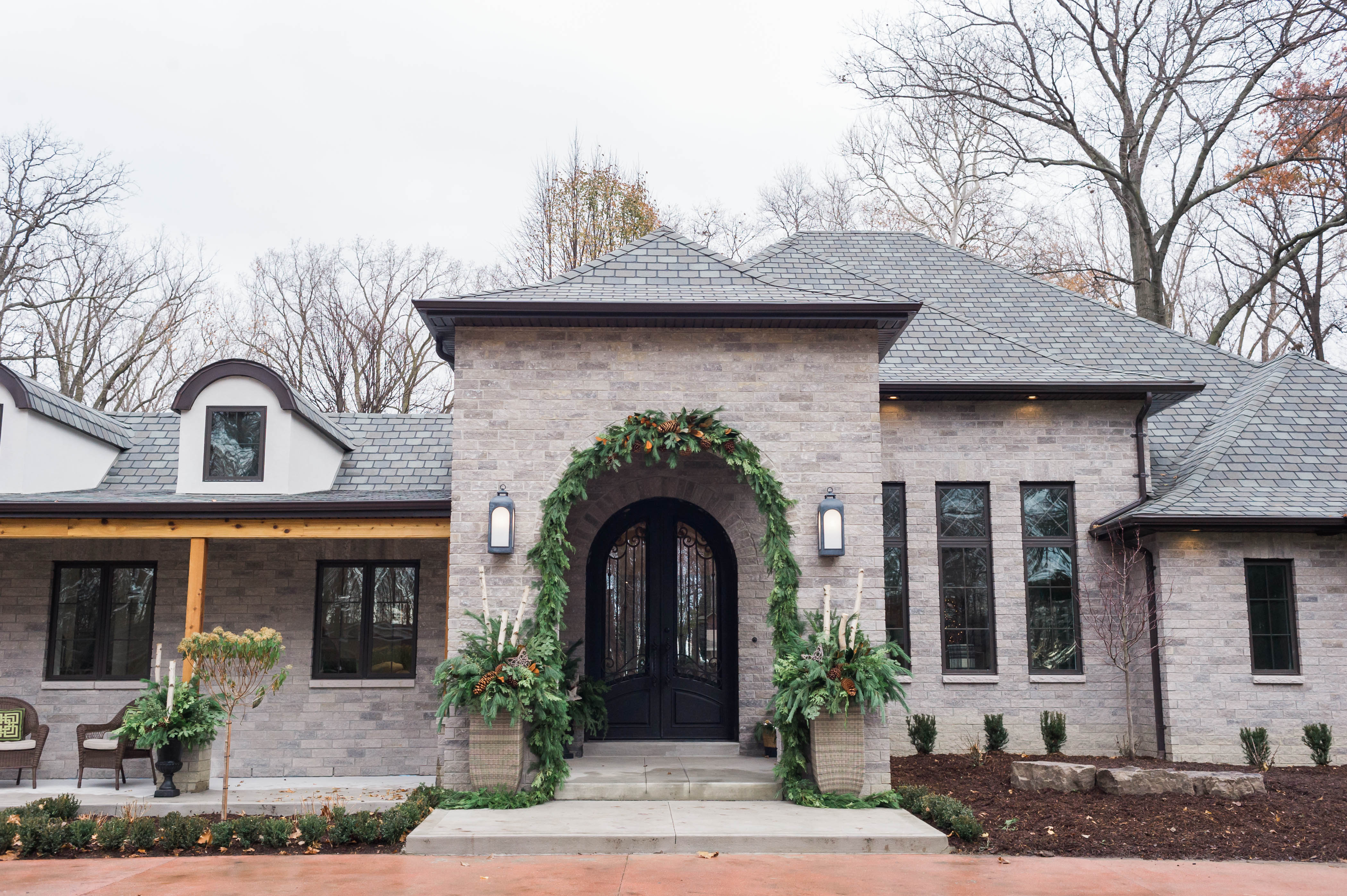 flared_roof_modern_french_country_renovation_porch_iron_doors