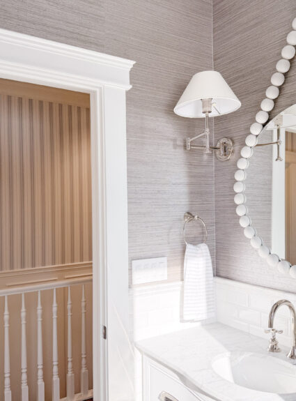 A Jewel Box Bathroom in Marble, Grasscloth, and Polished Nickel